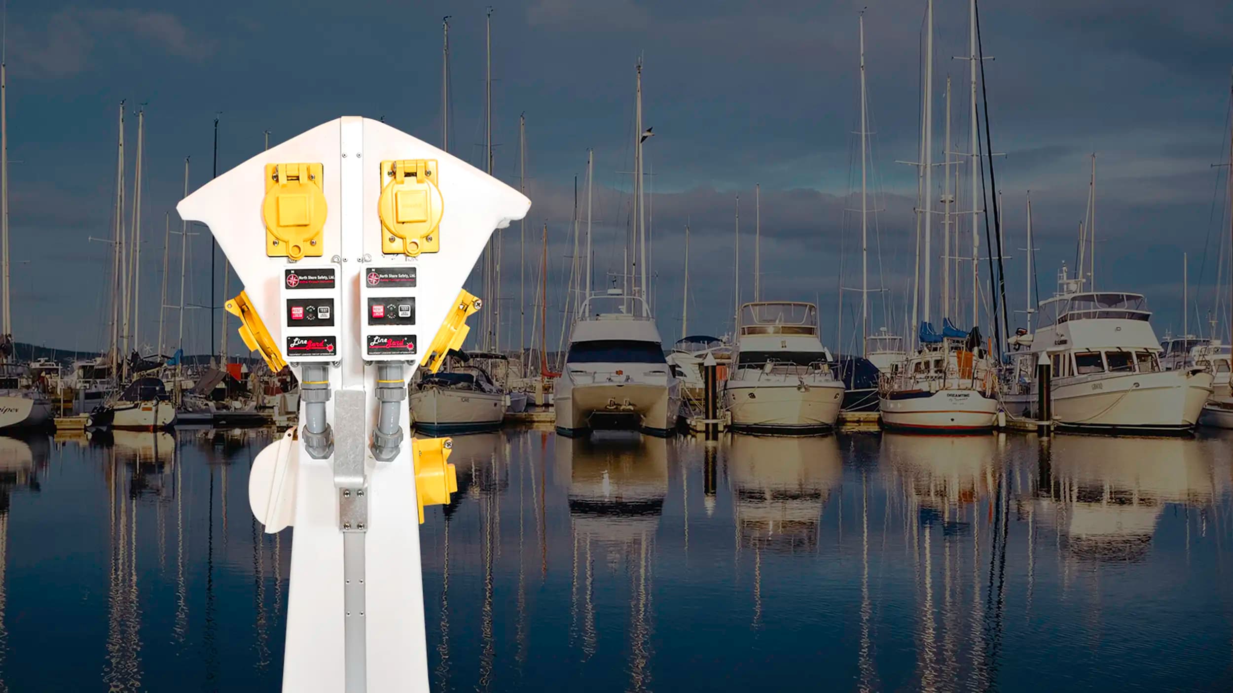 image of a marine pedestal equipped with North Shore Safety 30A ELCI in front of a marina