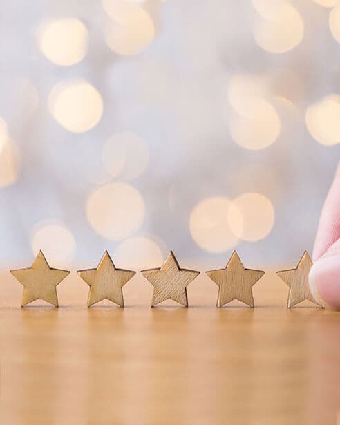 Image of 5 stars on a wooden surface
